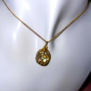 Intricate Gold Necklace with White Zirconia Encased in a Cage